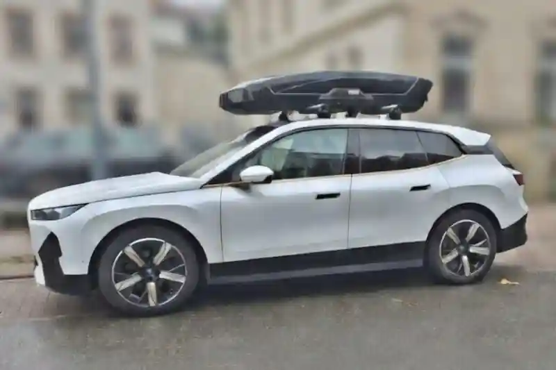 Eine XXL Motion Dachbox von THULE mit Wingbar-Alu-Dachträgern auf einem BMW iX